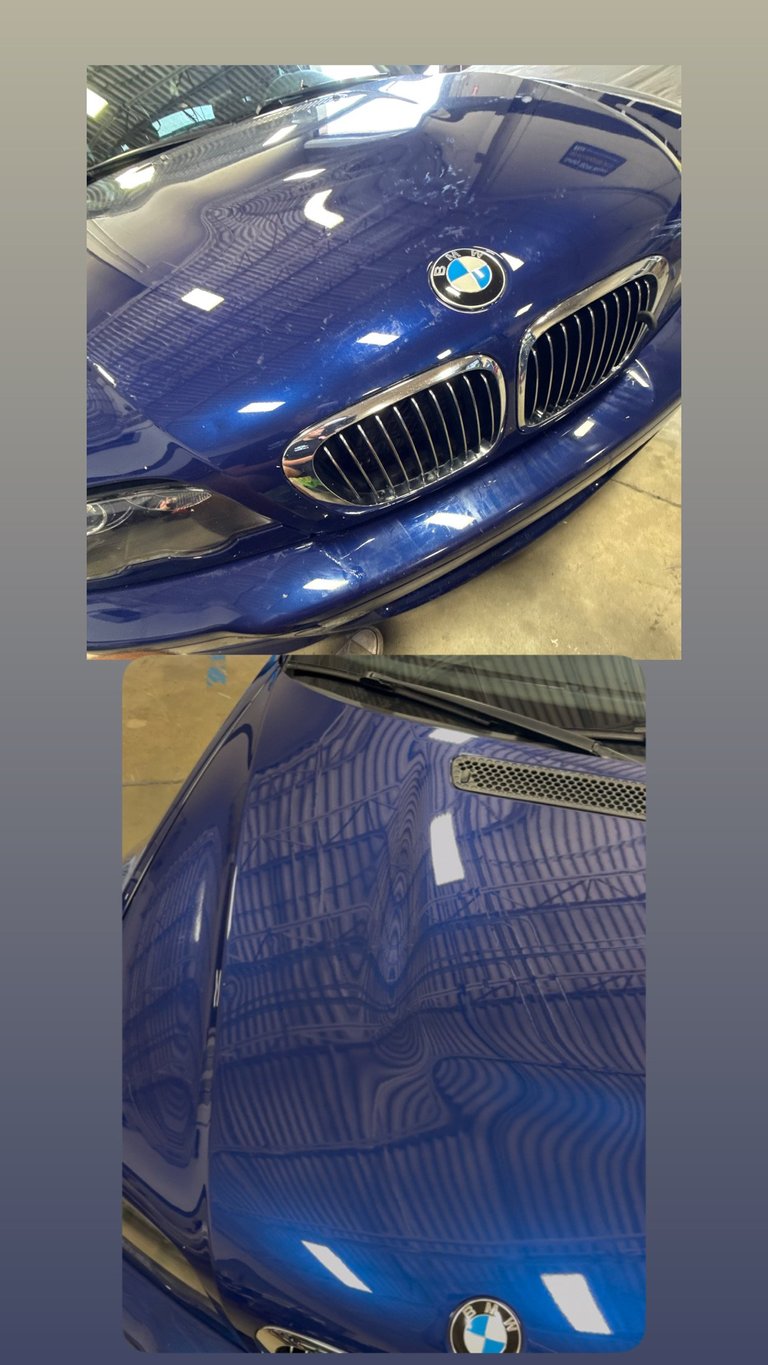 Close-up of a blue BMW car showing the front hood, grille, and hood emblem in a garage